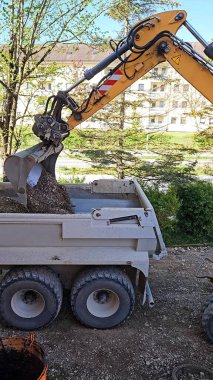 Kazıcı Çöp Kamyonu Yükleme: Toprak Taşıyıcı İnşaat Alanı. Yüksek kalite fotoğraf