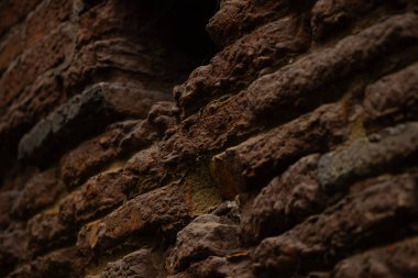 A detailed closeup image of a textured brown stone wall that beautifully showcases its unique and intricate patterns clipart