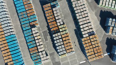 A colorful array of shipping containers is neatly organized at a port, highlighting industry, trade, and logistics clipart