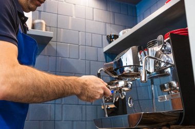 Küçük işletmesinde kahve hazırlayan profesyonel bir barmen..