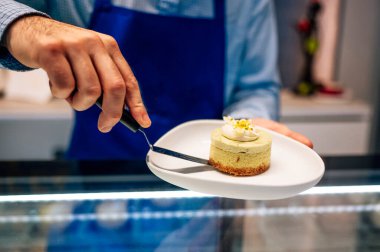 Küçük bir işletmede el yapımı peynirli kek satan bir adam..