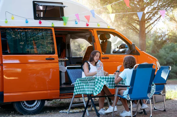 The family eats on a wonderful day of camping. Van life concept.