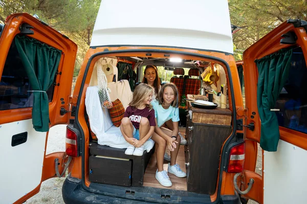 Happy children have fun on a wonderful camping day. Van life concept.