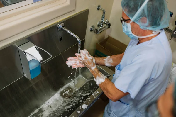 doctor washing his hands in the operating room.