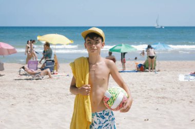 Gençler sahilde top oynayarak harika bir gün geçiriyorlar..