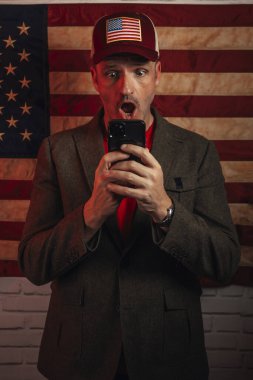 Euphoric American man with smartphone. clipart