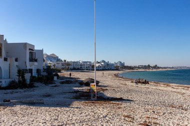 Beyaz kumlu bir sahil manzarası ve Port el Kantaoui 'de beyaz çatılı mavi bir deniz - Susa - Tunus