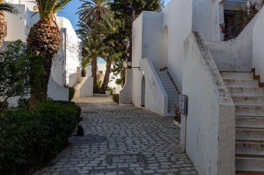 white houses and narrow street in Port el Kantaoui - Sousse - Tunisia clipart