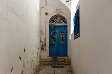 traditional arabic door of house in narrow street of medina in Sousse - Tunisia clipart