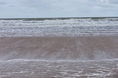 waves in sea at beach in Tal-y-bont - Gwynedd - Wales - Great Britain clipart