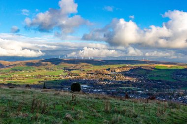 a beautiful view of the countryside with towns and wind turbins  from the hills in Holcombe - Greater Manchester - Lancashire - United Kingdom clipart