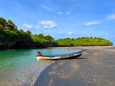 The fisherman's boat stopped at the edge of Ngiroboyo Beach clipart