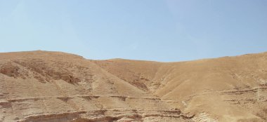 Altın rengi yüksek kum dağları olan çöl manzarası. Yüksek mavi gökyüzü ve tamamen ıssız vahşi yaşam, insan yapımı doğa değil..