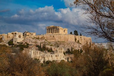 Parthenon among clouds against blue sky, on a mountain, Acropolis of Athens, Greece. High quality photo clipart