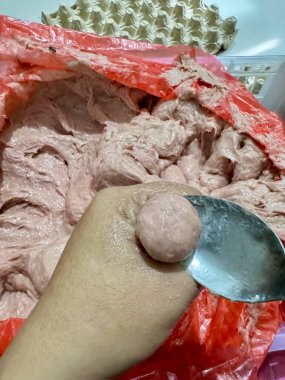 Crafting delicious homemade fish balls with fresh ingredients in a traditional kitchen for a tasty family meal experience