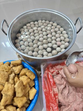 Authentic Indonesian meatball soup preparation with savory tofu and tasty broth for a delicious cultural food experience at home