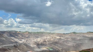 Dramatic quarry landscape under cloudy skies perfect for industrial projects or environmental impact stories showing scale and transformation