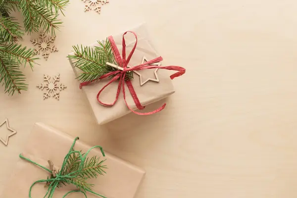 Christmas and zero waste, eco-friendly natural packaging gifts in craft paper on a wooden table, eco Christmas holiday concept, eco decor banner with copy space