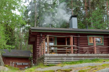 Finnish summer sauna house in the archipelago, island with pine forest in Finland near the Baltic sea, preparing and heating sauna clipart