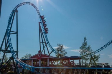 Helsinki, Finlandiya - 19 AUGust 2024: Linnanmaki lunaparkı hareket halindeki hız treni Taiga, arka planda mavi gökyüzü, mutlu insanlar