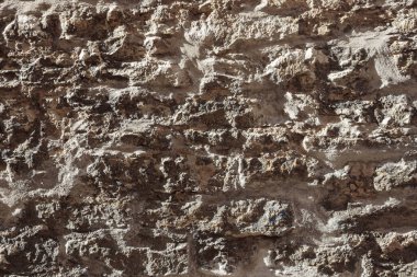 Taş bir duvarın dokusu. Eski kale taşından duvar dokusu. Arka plan ya da doku olarak taş duvar. Bir taş duvarın parçası, arkaplan veya doku için