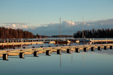 Sonbaharda deniz marinası, sakin bir denizde terk edilmiş yelkenliler, boş marina limanı, Finlandiya 'da sonbahar yelken mevsimi, Suomenoja