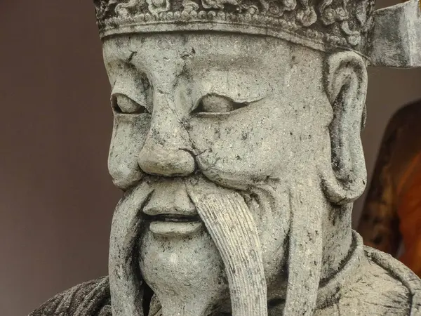 stock image A close-up view of an intricate statue at Wat Phu in Bangkok, Thailand. The detailed craftsmanship highlights the cultural significance of the temple.