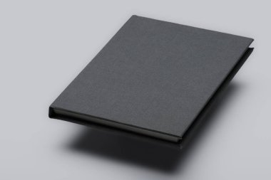 Gri yüzen kitap modeli. Beyaz arka planda izole edilmiş gölgeli boş bir kitabın stüdyo görüntüleri. Üç Boyut