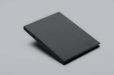 Gri yüzen kitap modeli. Beyaz arka planda izole edilmiş gölgeli boş bir kitabın stüdyo görüntüleri. Üç Boyut