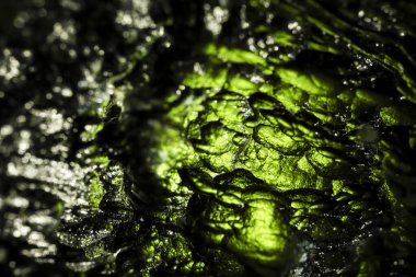 Tektite, natural glass formed during a meteorite impact. Beautiful green gemstone. Precious rare mineral. Illegal mining of moldavites in Czechia. Rough sharp surface. Alternative therapy. clipart