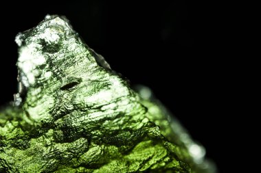 Genuine bohemian moldavite gemstone close up. Tektite, natural glass formed during a meteorite impact. Beautiful green gemstone. Precious rare mineral. Illegal mining of moldavites in Czechia. Alternative therapy. clipart