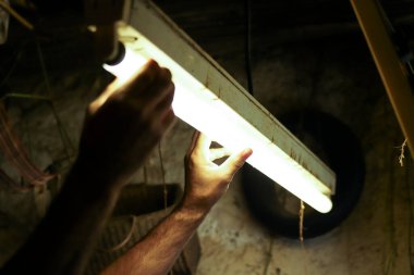 Erkekçe kollar keskinleştiriyor ve çekiç kullanarak eski bir bıçağı onarıyor.