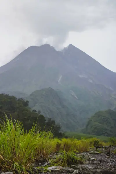 Endonezya 'da bulutla kaplı volkanik dağ manzarası.