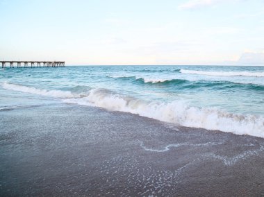 Blue Waves Crashing and Pier Beach Wilmington North Carolina clipart