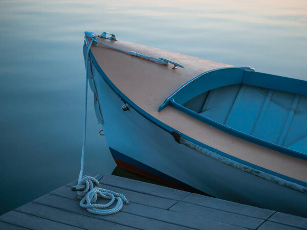 Twilight Peaceful Blue Boat in Still Water Tied to Fishing Pier Dock 
