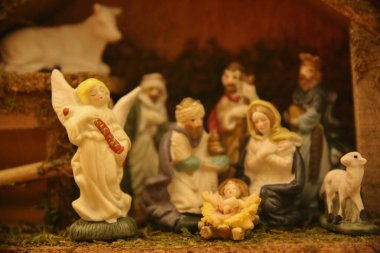 traditional nativity scene depicts the birth of Jesus with various figurines clipart