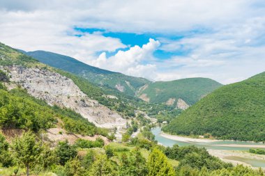 The Valbona river flows into lake Kamoni in north Albania clipart