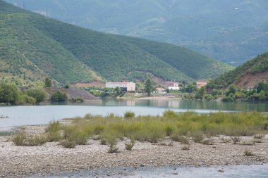 The Valbona river flows into lake Kamoni in north Albania clipart