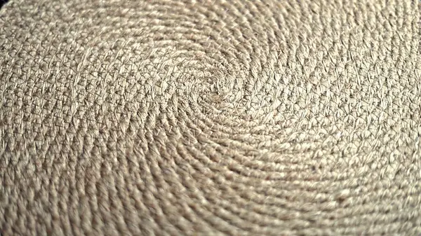 stock image Straw arranged in spiraled circular pattern, showcasing detailed fiber texture under soft light. Natural material highlights craftsmanship, evoking simple elegance