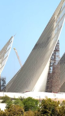 Abu Dhabi, UAE - September 8, 2024:Zayed National Museum merges contemporary design, traditional Emirati architecture glass atriums inspired by falcon wingtips create blend of culture and innovation clipart