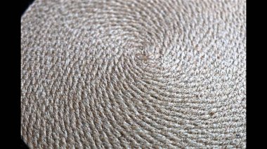  Straw texture shows intricate spiral pattern. Fibers form tight loops with rough texture, emphasizing natural craftsmanship. Soft light enhances rustic, organic details.  clipart