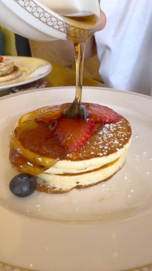 Krep üzerine serpiştirilmiş akçaağaç şurubu gurme kahvaltı deneyimi sergiler, yemek hastalarına hitap eden zarif, kaliteli yemek ve mutfak sanatları merkezli temalar için harikadır..