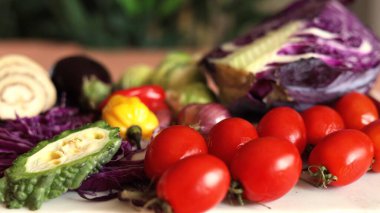 Mixed vegetables like red tomatoes, yellow peppers, purple cabbage, and green leafy greens create colorful eco display. Organic ingredients promote natural sustainable lifestyle. clipart