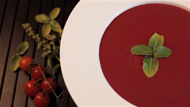 Beetroot soup on black background, with cherry tomato enhances wholesome elegance, offering red tones, nutritional value, and beautifully plated clean-eating option. Balanced lifestyle concept. clipart