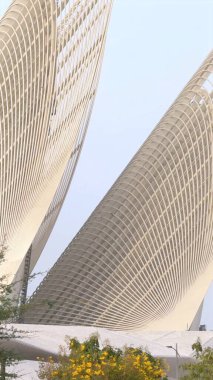 Abu Dhabi, UAE - December 2, 2024:Modern architectural marvel combines dynamic geometric forms with organic inspiration. Innovative structure fluid design bridges futuristic creativity  clipart