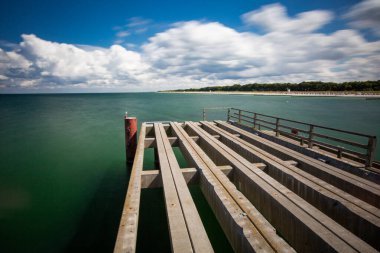 Wooden pier at baltic sea at the penisula Darss, Germany - long exposure clipart