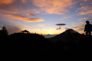 Dieng - Wonosobo, Indonesia - May 29, 2018 People enjoy beautiful Golden Sunrise Sikunir view of the Dieng Wonosobo clipart