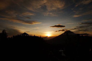 Dieng - Wonosobo, Indonesia - May 29, 2018 People enjoy beautiful Golden Sunrise Sikunir view of the Dieng Wonosobo clipart