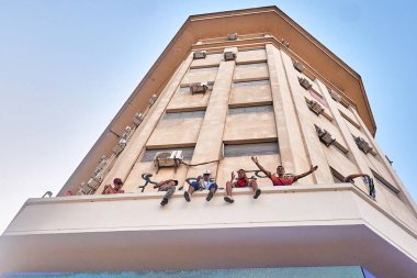 Celebrating the World Cup in Argentina. Delinquents on top of a building celebrating the World Cup victory. Buenos Aires, Argentina - December 18, 2022 clipart