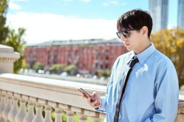 Şehir Korkuluğu Yakınındaki Genç Profesyonel Kontrol Telefonu